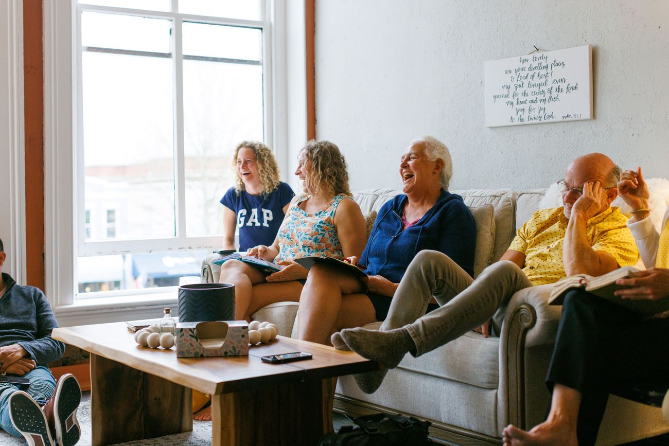 Amy laughing with friends at a prayer gathering
